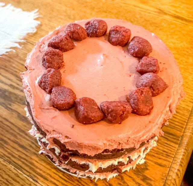 https://www.mealfinds.com/wp-content/uploads/2022/01/top-of-red-velvet-milk-bar-cake-milk-bar-birthday-cake-reviews-mealfinds.jpg
